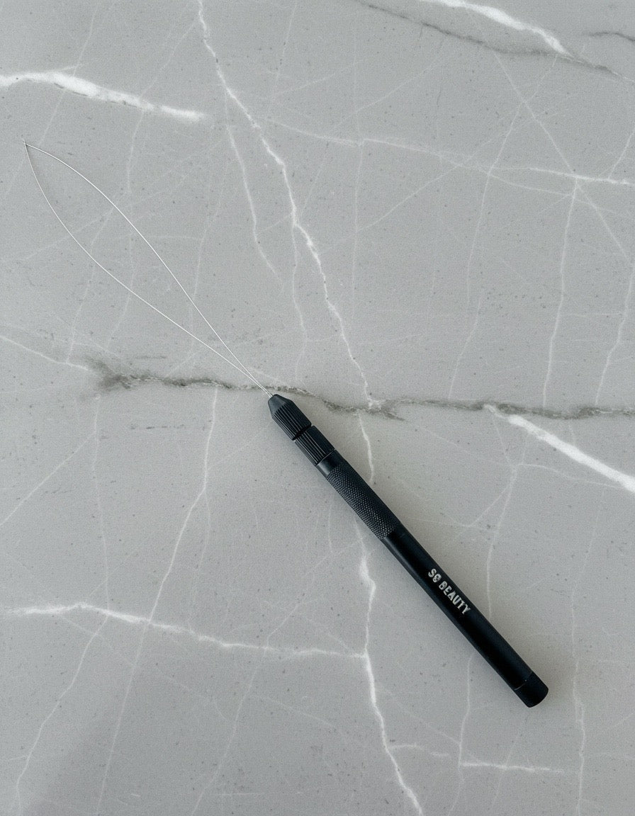 A black stylus pen with white text reading 'BE READY' lies diagonally on a light gray marble-patterned surface.
